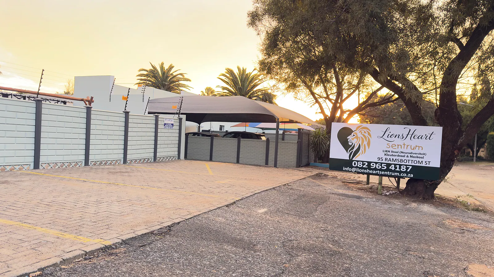 Lions Heart Sentrum entrance and school sign in warm sunset light